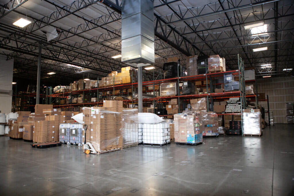 One of Xcel Delivery's distribution warehouses with various stacks of packages prepared for delivery service