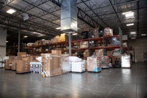 One of Xcel Delivery's distribution warehouses with various stacks of packages prepared for delivery service