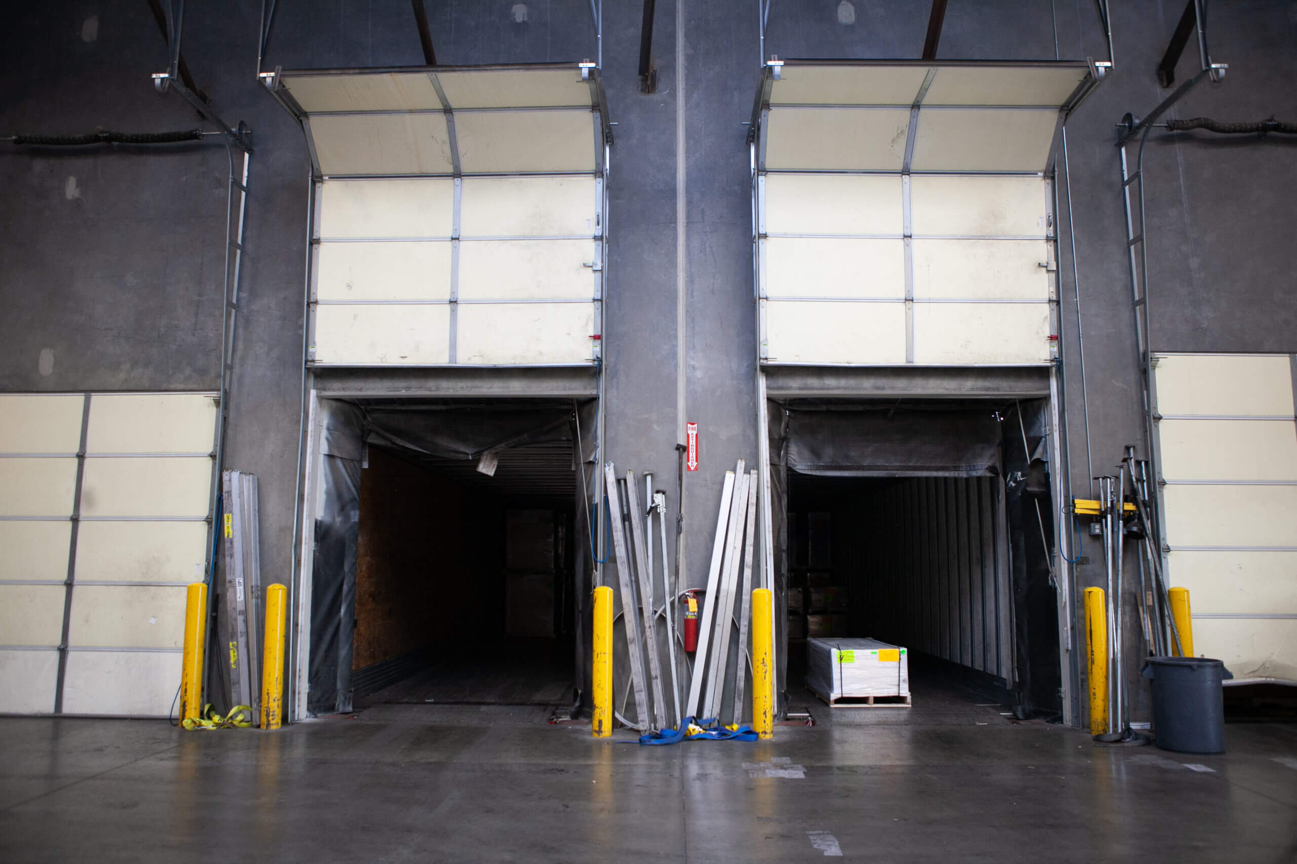 4 loading bays at the Phoenix distribution center with 2 garage doors open and 2 closed