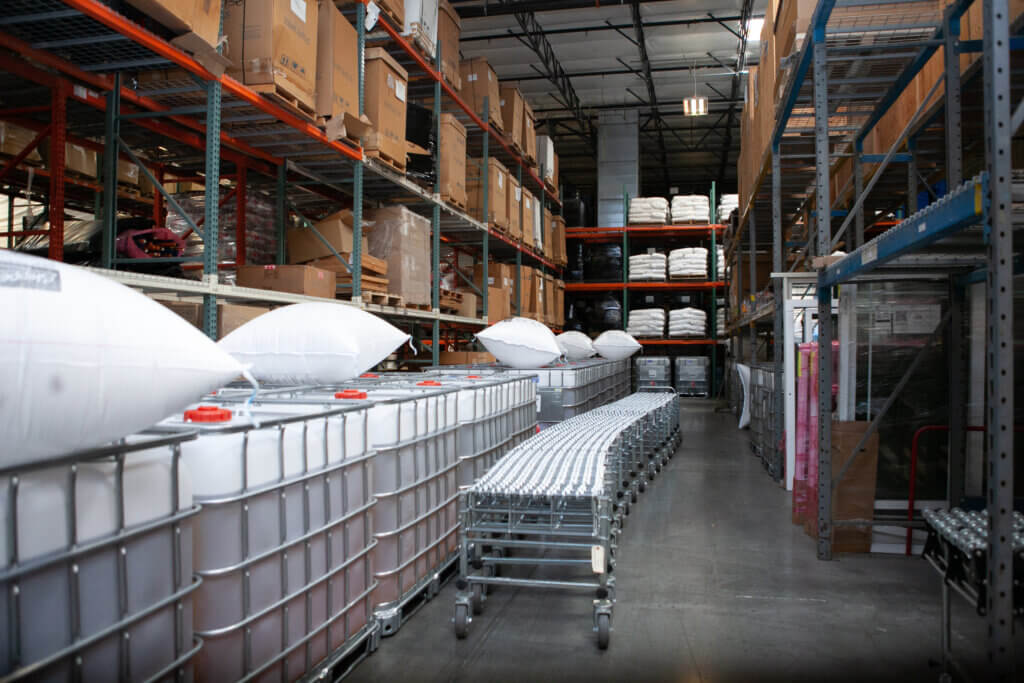 Carts that are filled with packages that are ready for delivery in one of Xcel Delivery's distribution warehouses