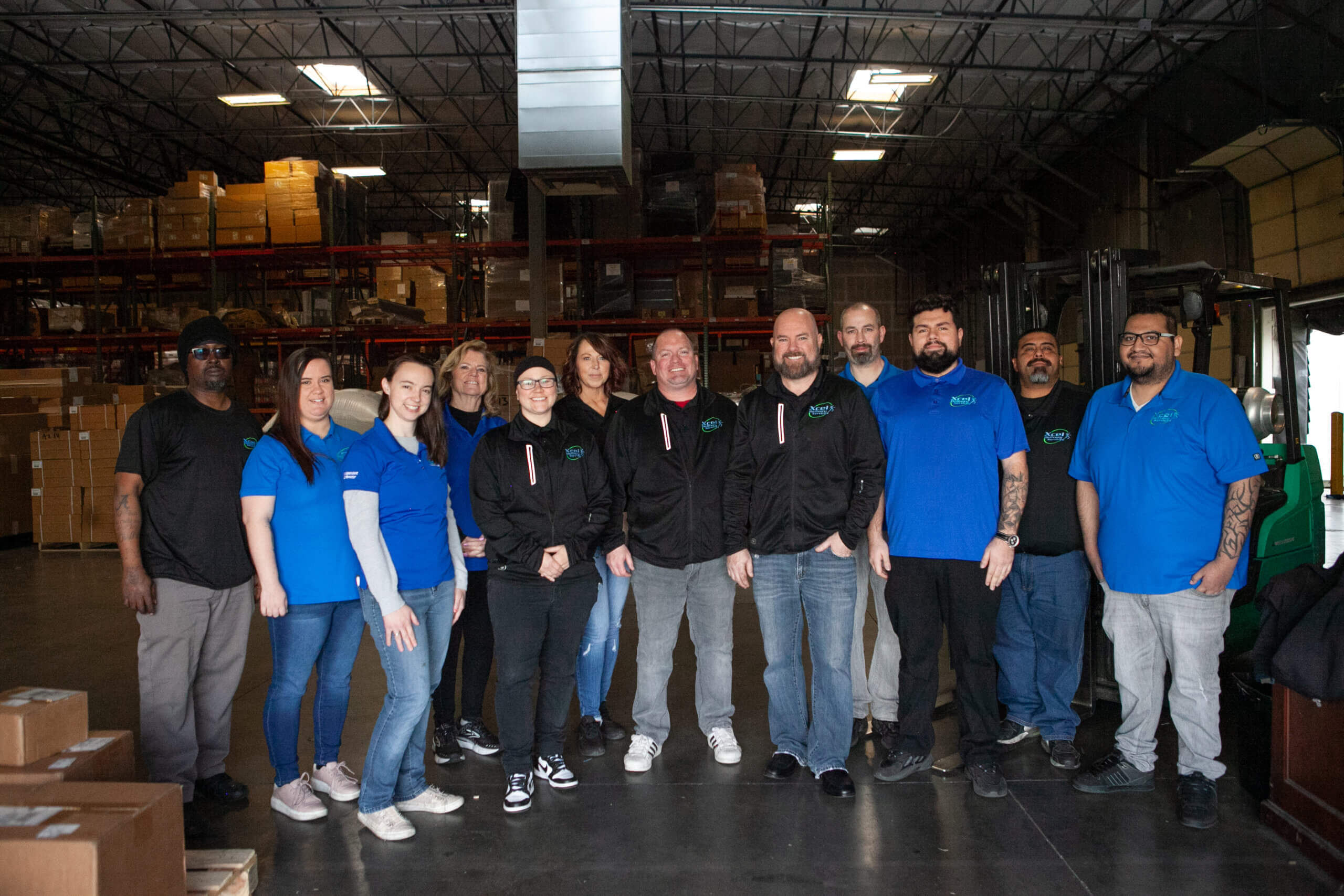 A large freight delivery service team standing in a warehouse in Tucson surrounded by boxes