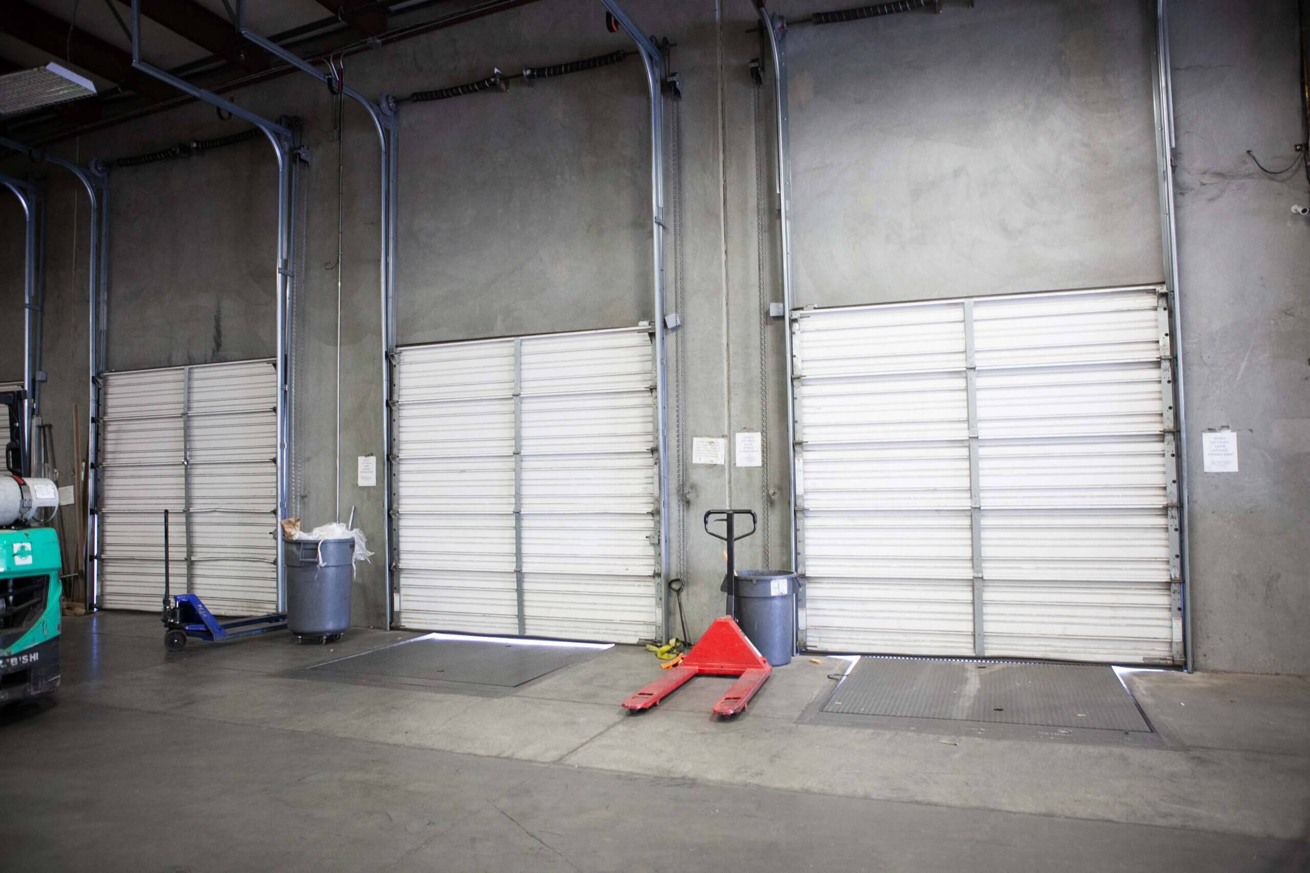 3 loading bays with closed garage doors in Xcel Delivery's Tucson AZ distribution center